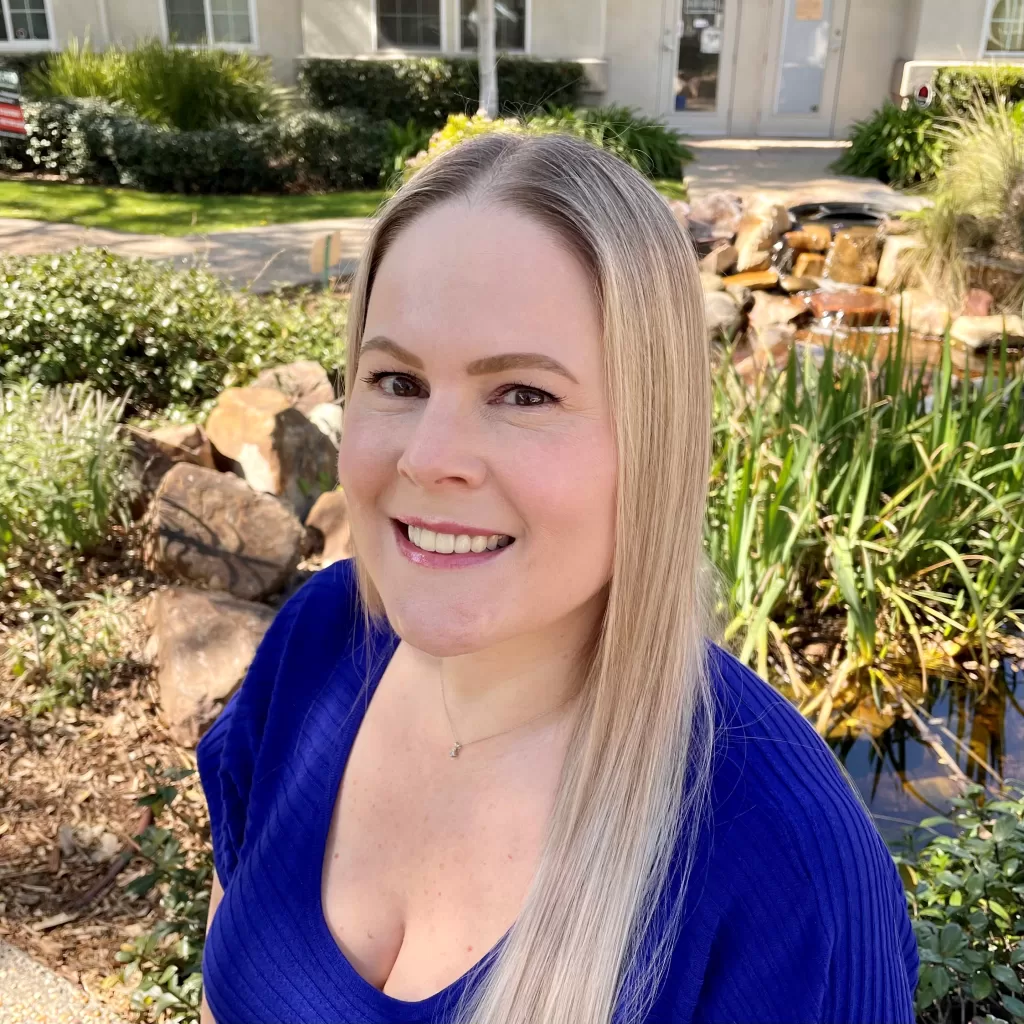 Lisa Jacobs wearing a blue blouse outside